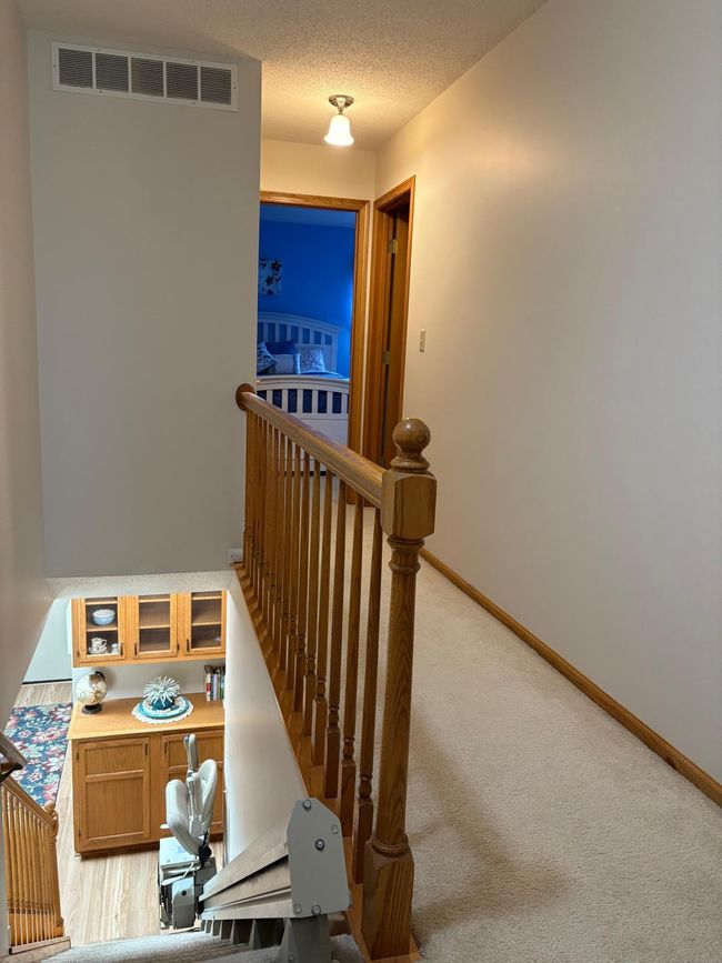 upstairs hallway and staircase showing chair lift | Image 42