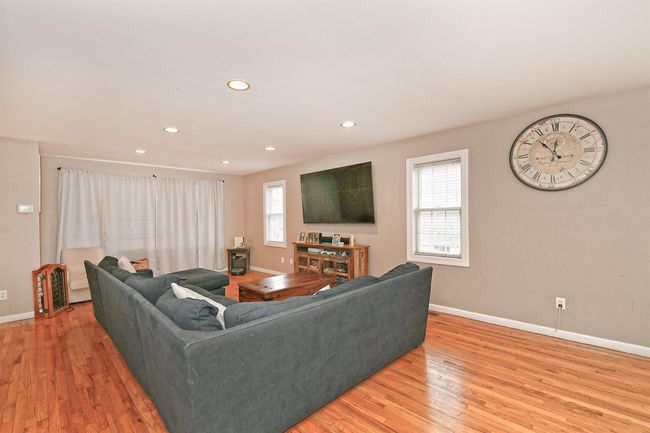 Living area featuring baseboards, a wealth of natural light, recessed lighting, and light wood-style floors | Image 13