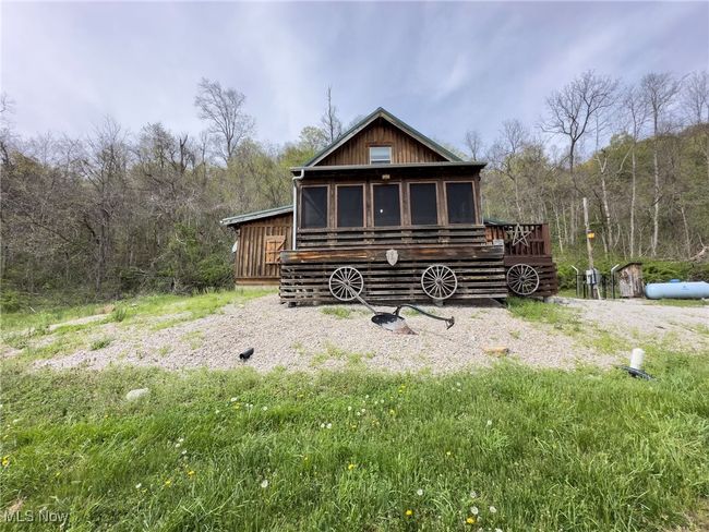 Rear view of property with a wooded view and a deck | Image 4