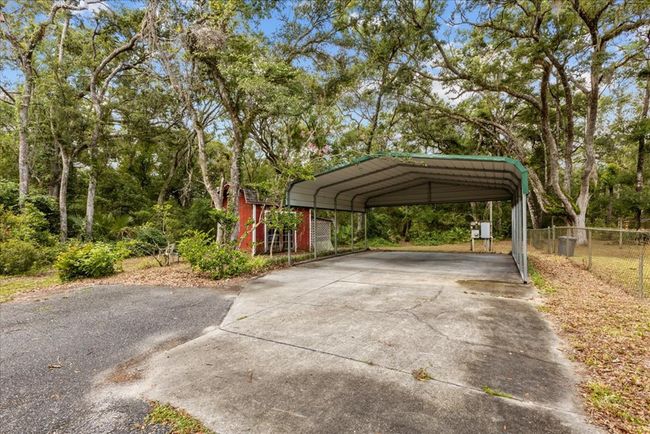 asphalt driveway to carport | Image 5