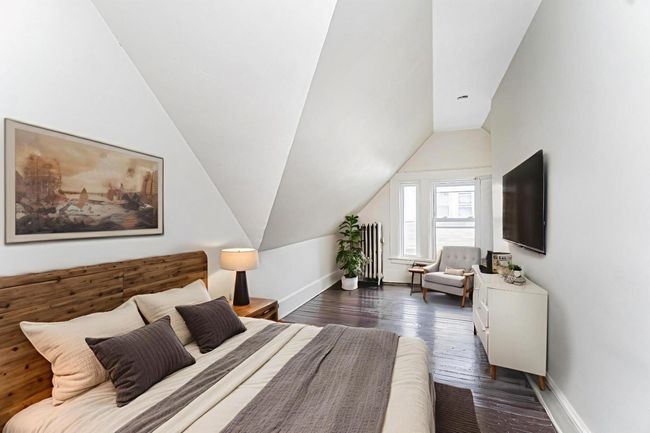 Bedroom featuring vaulted ceiling and dark wood finished floors | Image 23