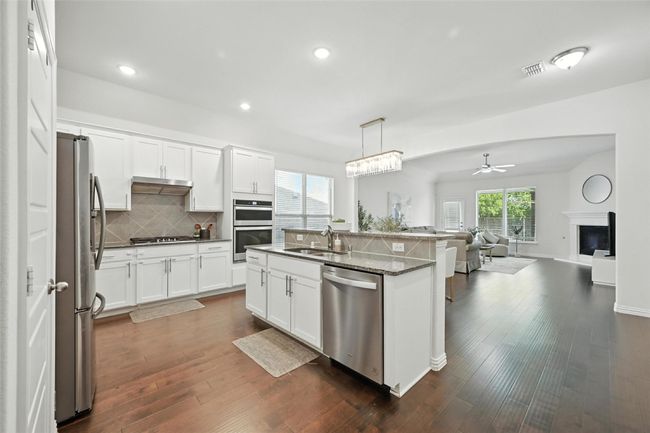 Kitchen with open floor plan, backsplash, healthy amount of natural light, appliances with stainless steel finishes, and recessed lighting | Image 7