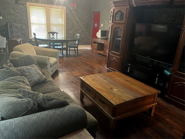 Open Living area with hard-wood flooring, ceiling fan and natural lighting | Image 19
