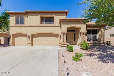 South facing front door with beautiful mature tree shading the front oversized windows. | Image 1