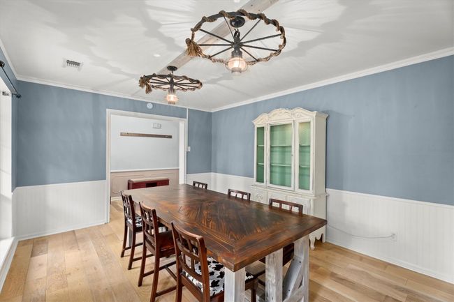 The dining room contains is bright allowing natural light to fill the space, highlighting the beautiful flooring. | Image 7