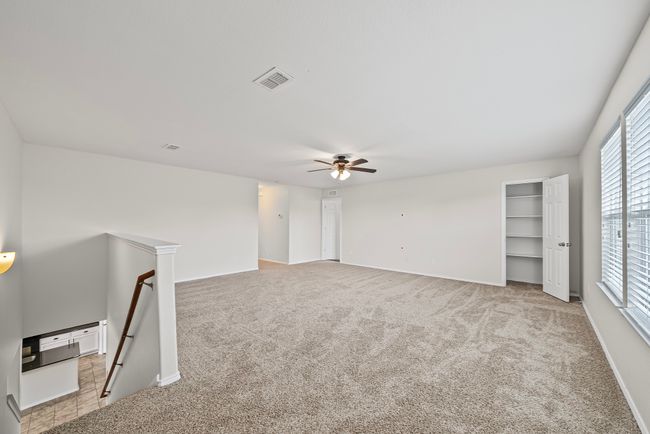 Carpeted empty room featuring ceiling fan and baseboards | Image 27