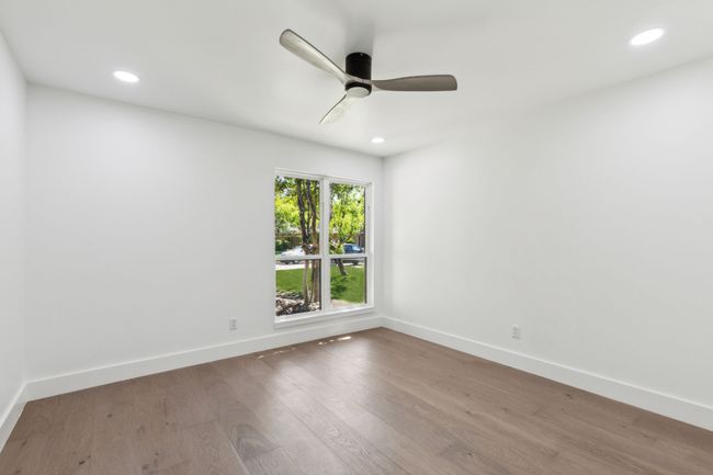 Large secondary bedroom with closet .and ceiling fan. | Image 22
