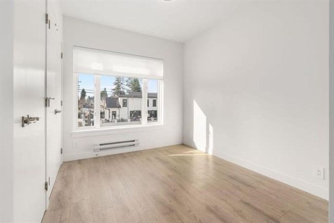 Unfurnished room featuring a baseboard heating unit, baseboards, and light wood finished floors | Image 11