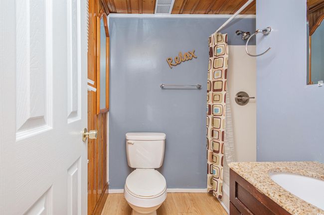 Bathroom featuring vanity, wood finished floors, and curtained shower | Image 31
