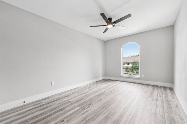 Spare room with wood finished floors, ceiling fan, and baseboards | Image 19