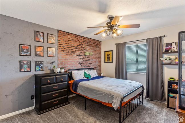 Bedroom with carpet, baseboards, a textured ceiling, and ceiling fan | Image 16