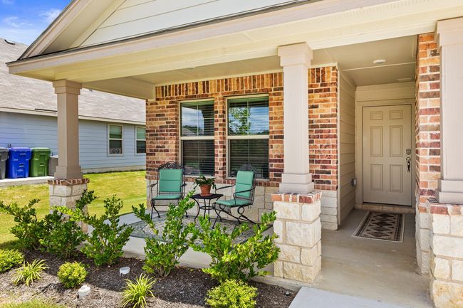 View of exterior entry featuring brick siding and covered porch | Image 6