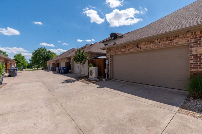 Attached two car garage with extra storage inside. Door is well insulated. Nice wide alley. | Image 19