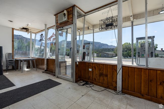 Interior space with a mountain view, a wall mounted AC, and wood walls | Image 12