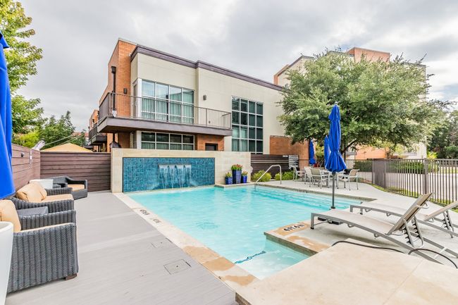 Dive into designer luxury with this sparkling pool, stylish seating, and lush landscaping. Whether you're hosting or relaxing solo, this space delivers that vacation feeling—every single day. | Image 17