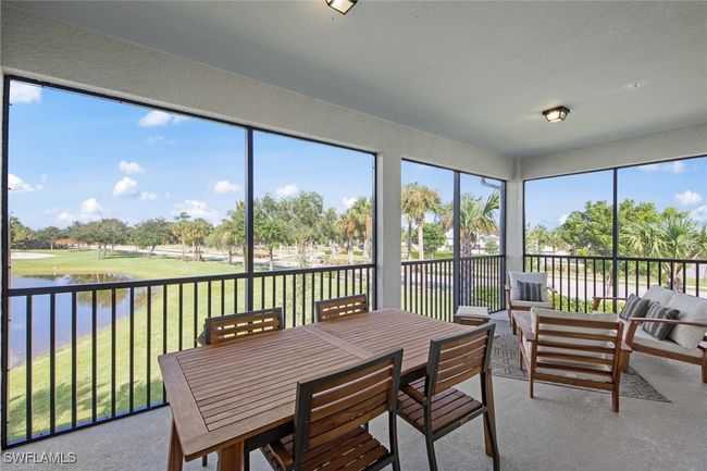 Sunroom featuring an outdoor living space, outdoor dining space, and a water view | Image 5