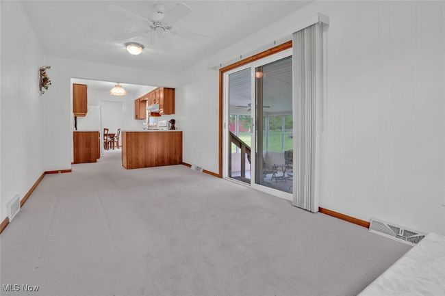 Unfurnished living room featuring baseboards, ceiling fan, and light carpet | Image 15