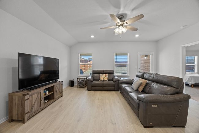 Living area with ceiling fan and light wood-look flooring | Image 14