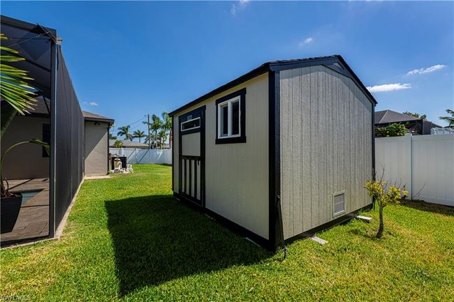View of shed featuring a fenced backyard | Image 31