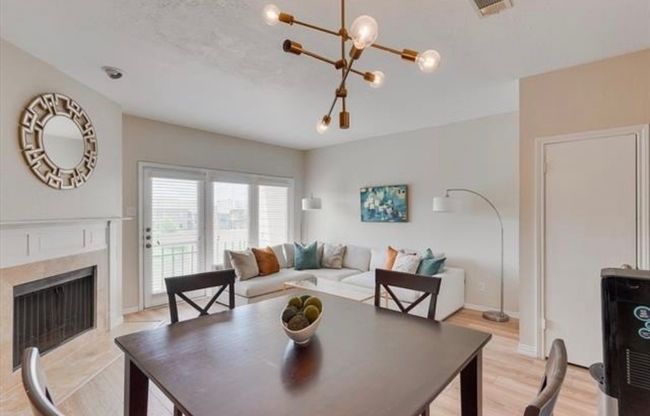 Dining area featuring a chandelier, light wood-style floors, and a premium fireplace | Image 9