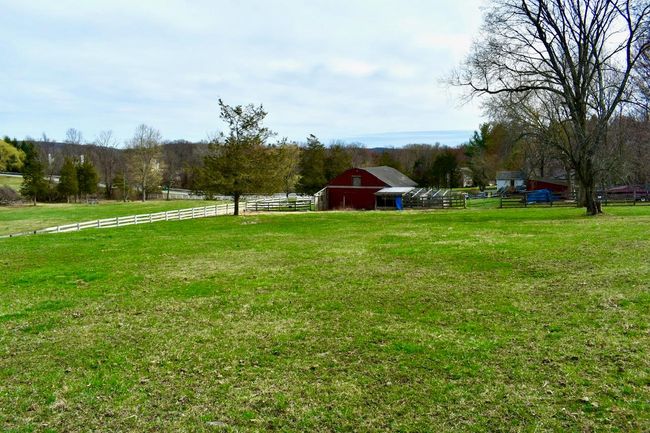 View from the back of the property looking toward the back of the barn and chicken coop area highlighting the abundant pasture | Image 31
