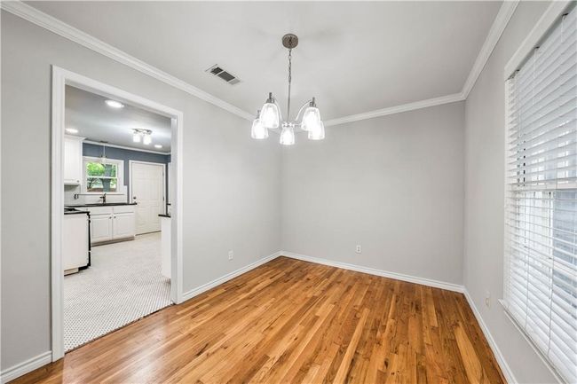 A look into the dining room after floors were refinished but before the kitchen was gutted. | Image 11