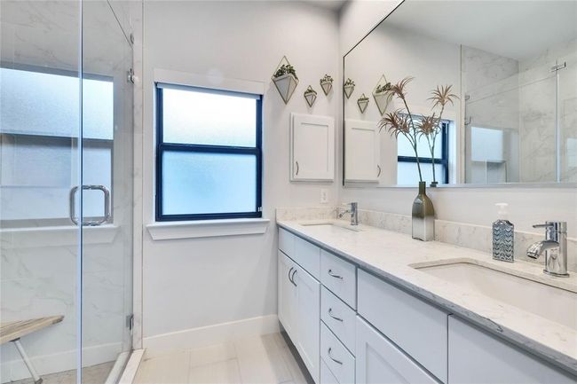Full bath with double vanity and a marble finish shower | Image 20