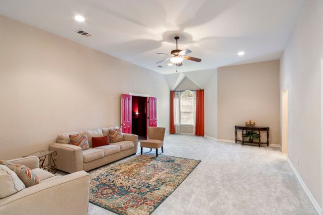 Living room featuring light carpet, a ceiling fan, baseboards, and recessed lighting | Image 26