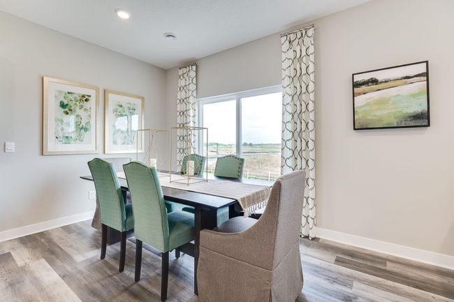 Dinette adjacent to the kitchen helps keep the conversation open and flowing from wherever you are on the main level. Previously built model home, finishes, selections, and colors to vary from future built home. | Image 11