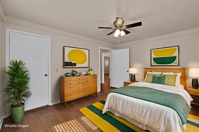 Bedroom featuring wood finished floors and ceiling fan | Image 5