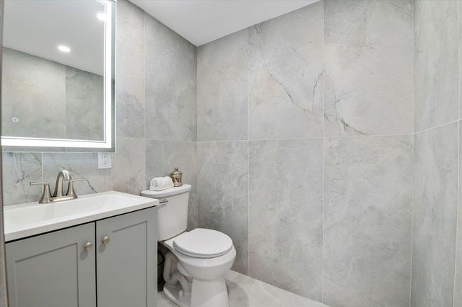 Bathroom featuring vanity and tile walls | Image 27