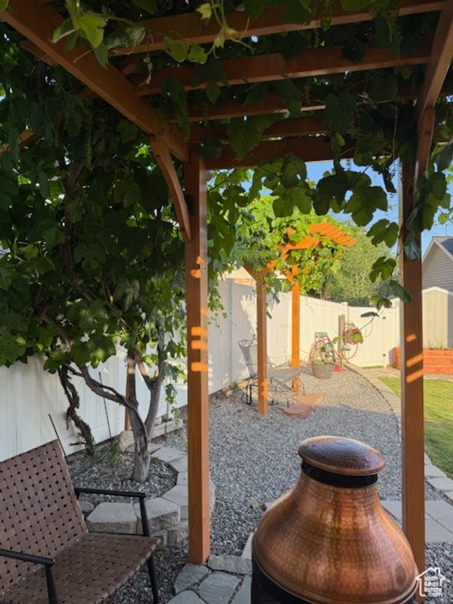 Fenced backyard with a patio area | Image 43