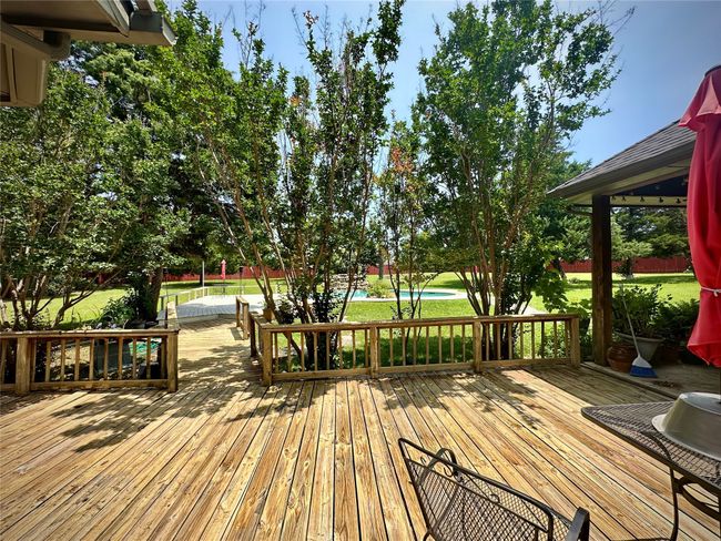 Wooden terrace featuring an outdoor​​‌​​​​‌​​‌‌​‌‌​​​‌‌​​‌‌​‌​​​​​‌ pool | Image 5