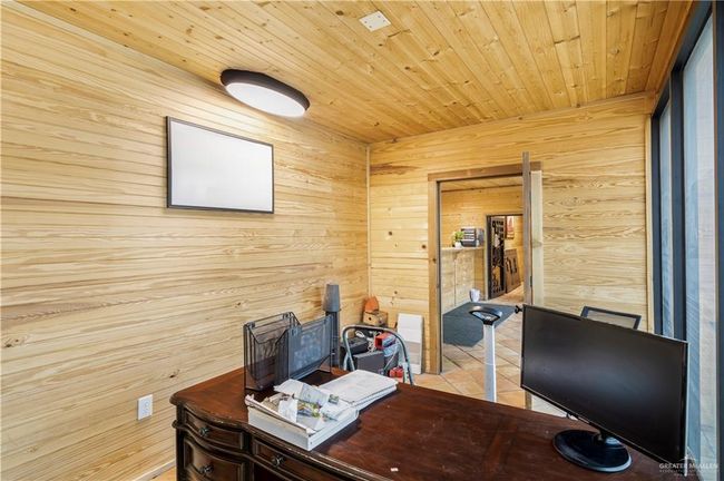 Tiled office space featuring wooden walls and wood ceiling | Image 22