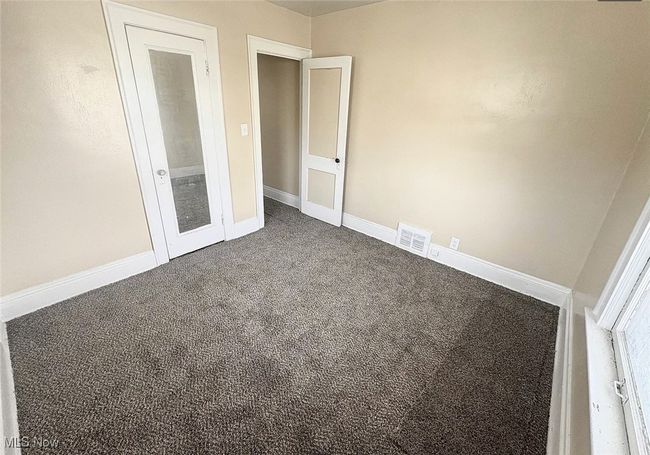 Unfurnished bedroom with visible vents, baseboards, and carpet floors | Image 10