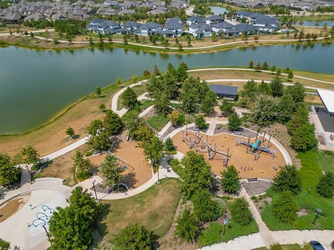 Features a single-family home with a spacious yard in Bridgeland, a master-planned community offering lakes, pools, sidewalks, and green spaces. | Image 25