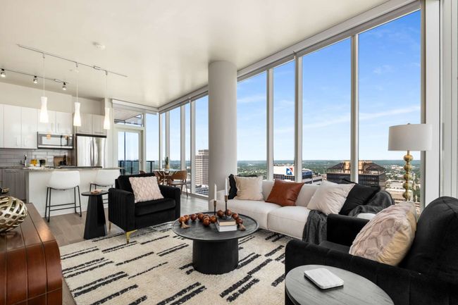 Imagine the ease of entertaining as conversations flow between the living room, dining, and kitchen, inviting your guests to relax among the clouds. | Image 25