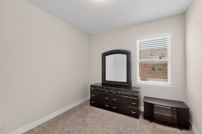 Unfurnished bedroom featuring baseboards and light colored carpet | Image 23