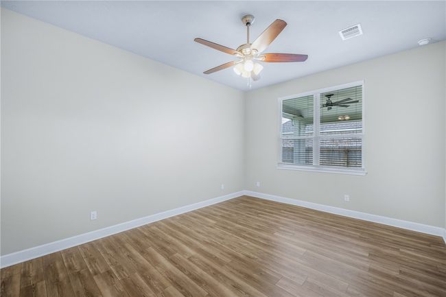 Unfurnished room with wood finished floors, ceiling fan, and baseboards | Image 25