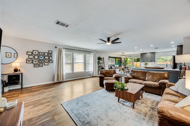 Living area with ceiling fan, light wood-type flooring, baseboards, and recessed lighting | Image 8
