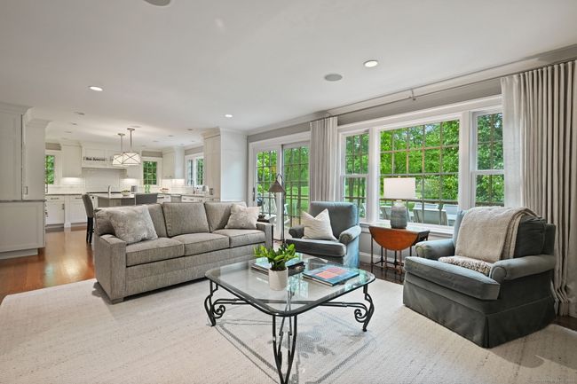 Serene family room off the kitchen with handsome built-ins and gas fireplace, and adjacent slider to oversized deck. | Image 7