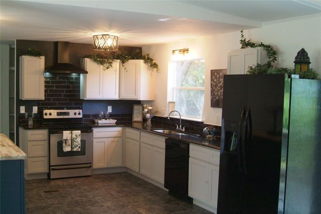 Kitchen with Real Wood Cabinets and uba tuba black granite countertops | Image 4