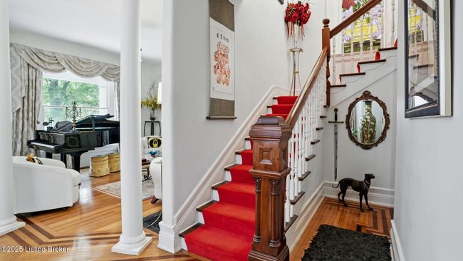 The grand staircase rising to the 2nd floor. | Image 8