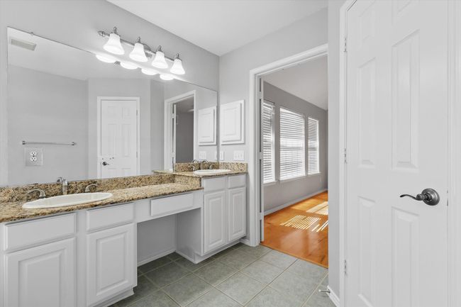Bathroom with tile patterned floors and double vanity | Image 19