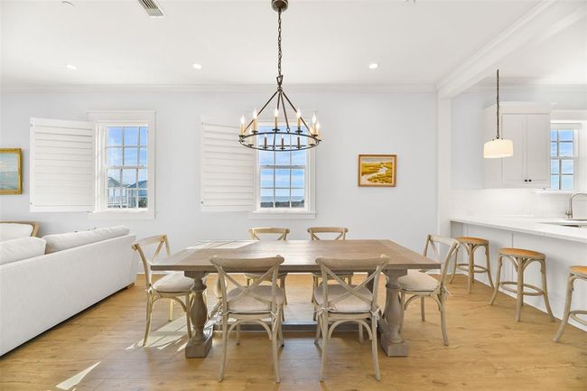 Dining area is located between living room and kitchen. | Image 12