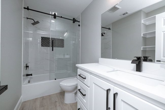 Full bath featuring vanity, wood finished floors, and bathtub / shower combination | Image 36