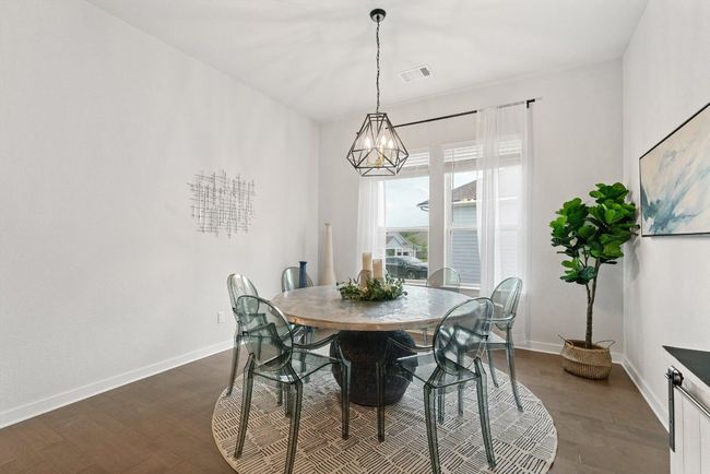 Dining space featuring a chandelier and dark wood finished floors | Image 9
