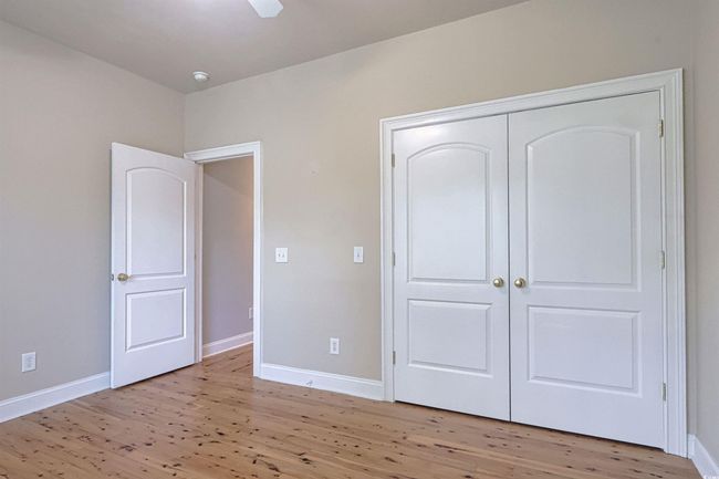 Unfurnished bedroom featuring light wood-type flooring, a closet, and ceiling fan | Image 14