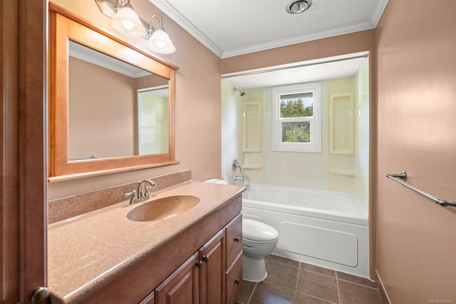 Bathroom featuring vanity, toilet, ornamental molding, bathing tub / shower combination, and tile patterned floors | Image 20