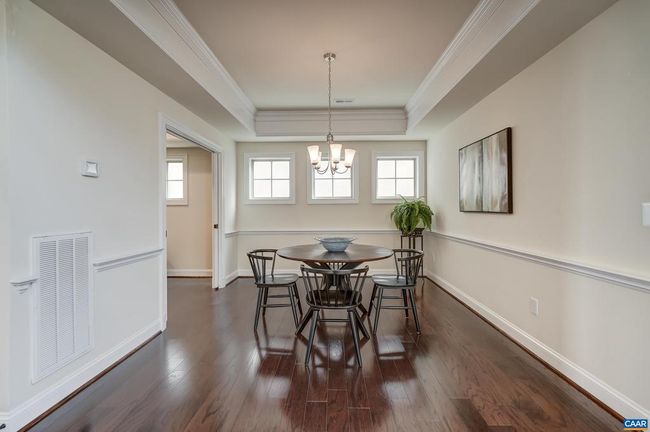 Formal dining room with chair rail and frosted windows. | Image 20